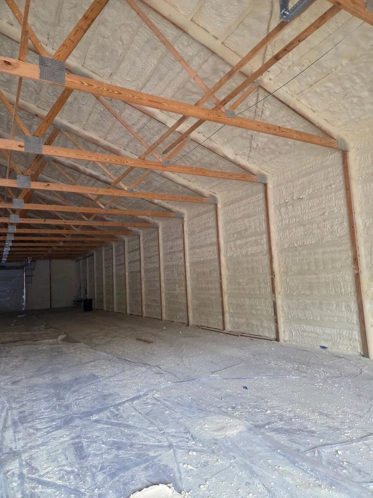 Long garage interior fully sealed with closed-cell spray foam insulation