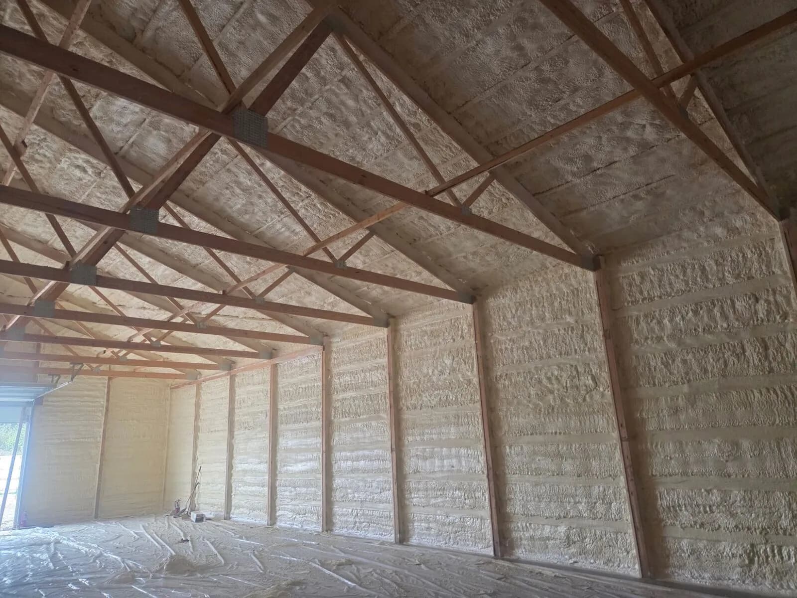 Full spray foam coverage on a post-frame shop interior in Eau Claire WI